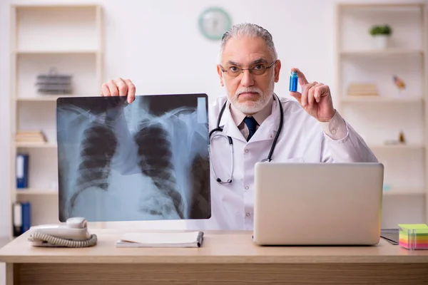 Gammal manlig röntgenläkare som arbetar på kliniken — Stockfoto