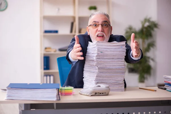 Old businessman employee unhappy with excessive work in the office — Stock Photo, Image