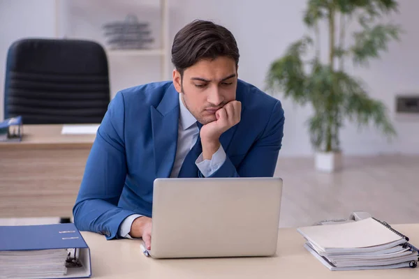 Young male employee sitting in the office — Stock Photo, Image