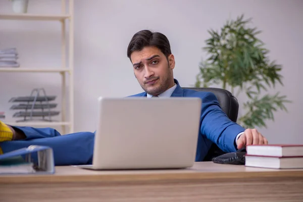 Young male employee being unhappy with excessive work — Stock Photo, Image