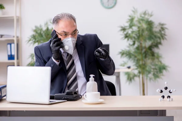 Viejo empleado jefe trabajando durante pandemia —  Fotos de Stock