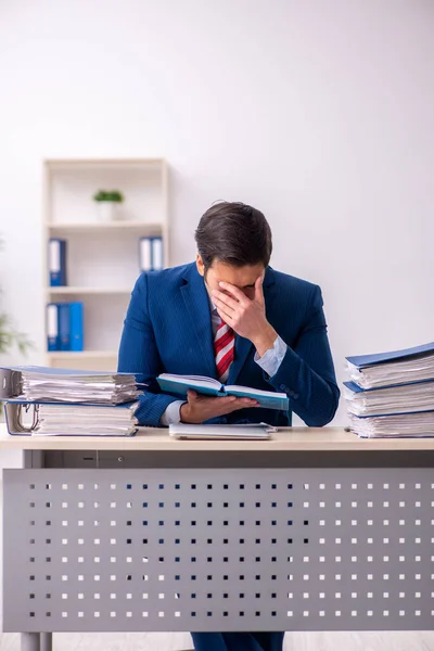 Ung manlig anställd missnöjd med överdrivet arbete på kontoret — Stockfoto