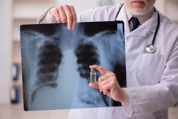 Gammal manlig röntgenläkare som arbetar på kliniken — Stockfoto