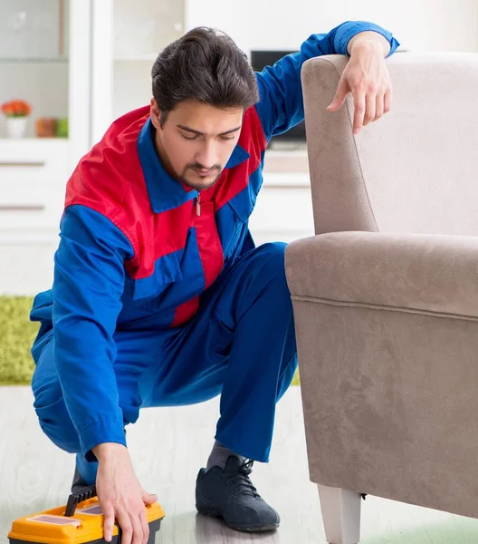 Repair contractor repairing broken furniture at home