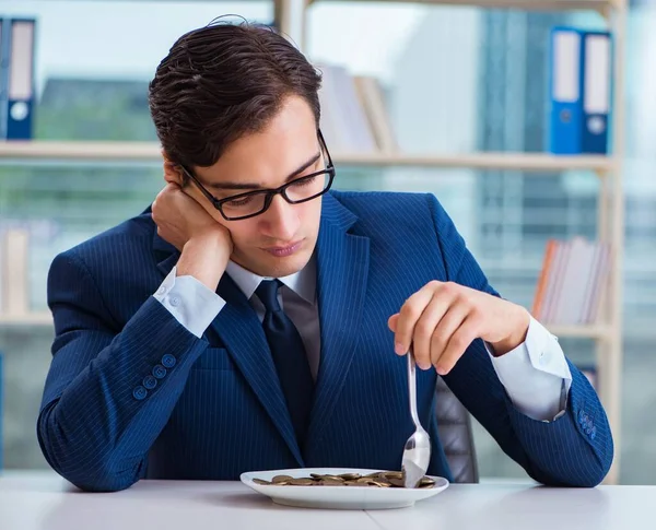 Divertido hombre de negocios comiendo monedas de oro en la oficina — Foto de Stock
