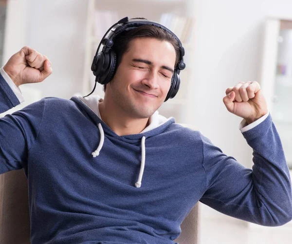 Jeune homme écoutant de la musique à la maison — Photo