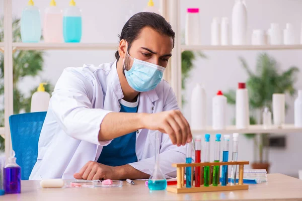 Jovem químico masculino testando sabão no laboratório — Fotografia de Stock