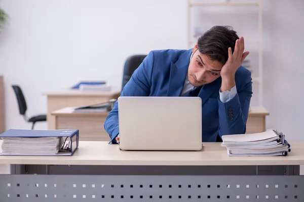 Ung manlig anställd som är missnöjd med överdrivet arbete — Stockfoto