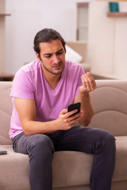 Genç adam salgın sırasında evde kalıyor.