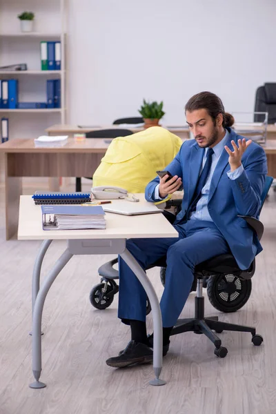 Jeune employé masculin s'occupant d'un nouveau-né sur le lieu de travail — Photo