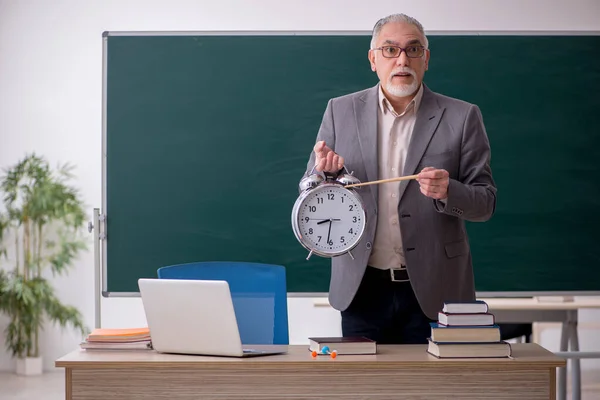 Old male teacher in time management concept — Stock Photo, Image