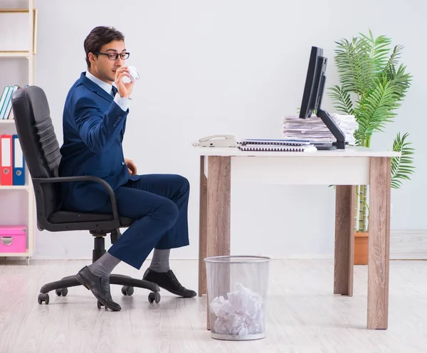 Молодой привлекательный бизнесмен работает в офисе в бумажной волоките — стоковое фото