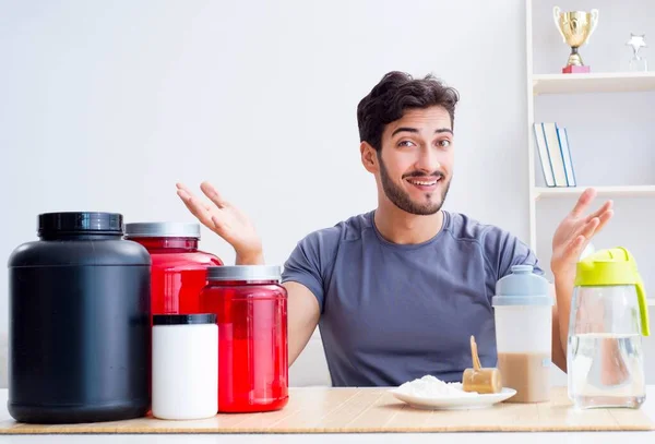 Athlete tasting new protein supplements for better muscles — Stock Photo, Image