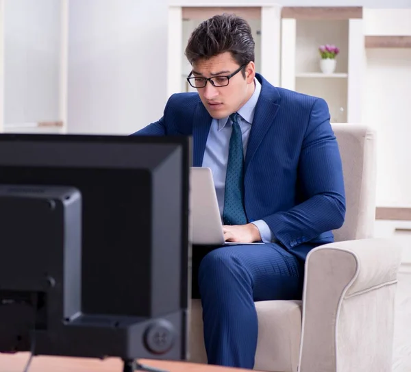 Businessman watching tv in the office — Stock Photo, Image