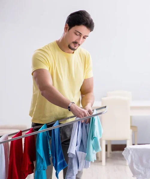 Handsome man husband doing laundering at home — Stock Photo, Image