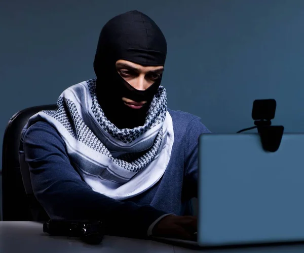 Hacker wearing balaclava mask hacking computer — Stock Photo, Image