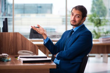 Ofiste çalışan genç bir erkek.