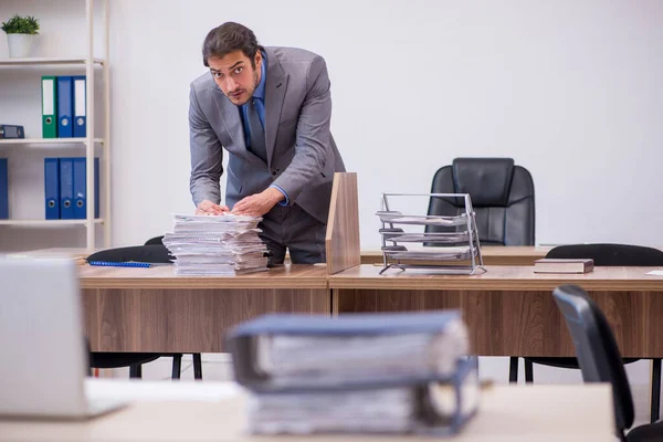 Young male employee in industrial espionage concept