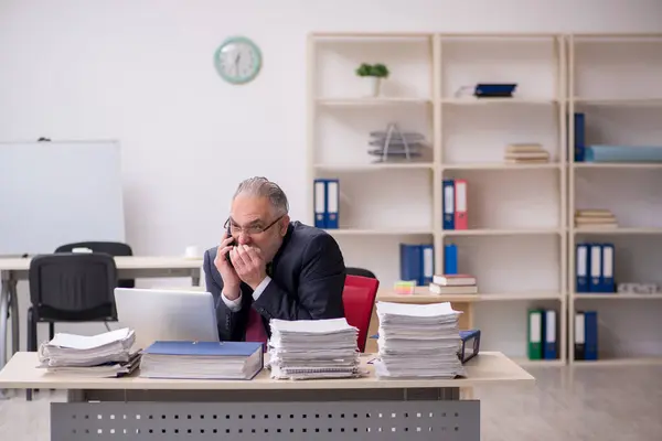 Idősebb férfi alkalmazott és túl sok munka a munkahelyen — Stock Fotó