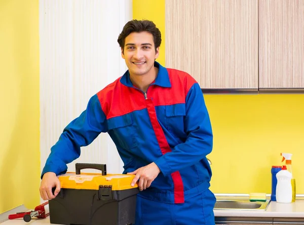 Plumber repairing tap at kitchen — Stock Photo, Image