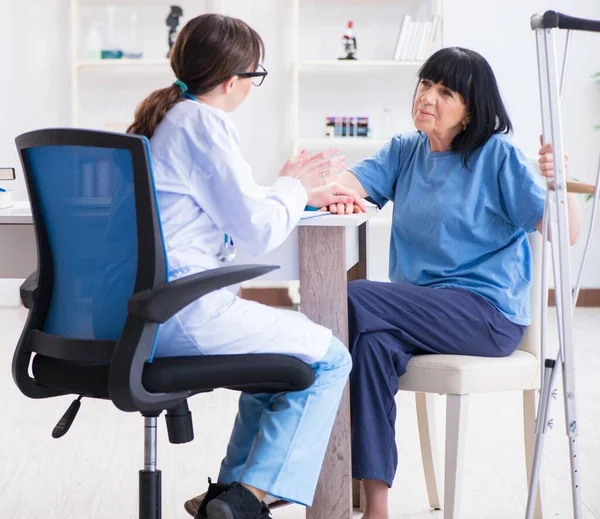 Dokter onderzoeken van oude volwassen vrouw na incident — Stockfoto