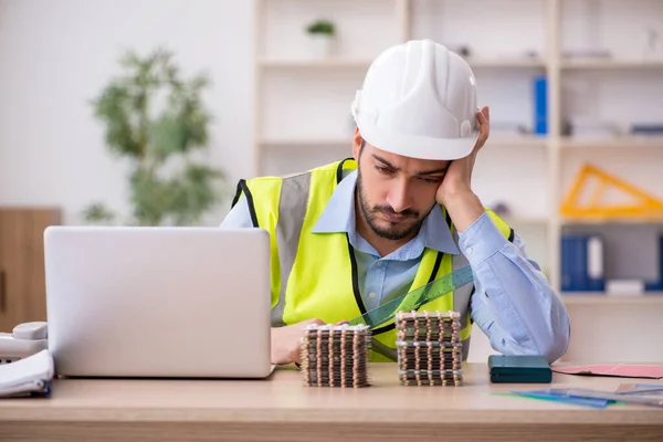 Young male architect suffering at workplace — Stock Photo, Image