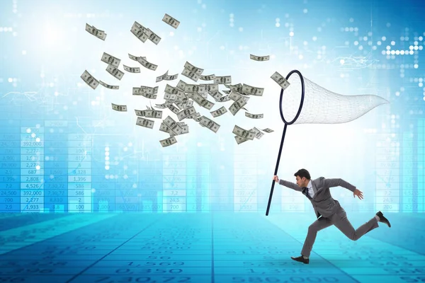 Young businessman catching dollars with landing net — Stock Photo, Image