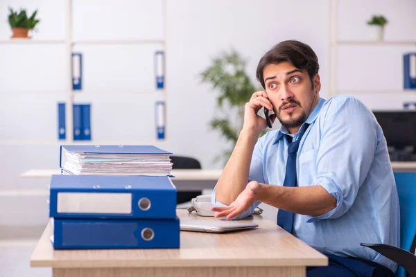 Junge männliche Mitarbeiter und zu viel Arbeit im Büro — Stockfoto