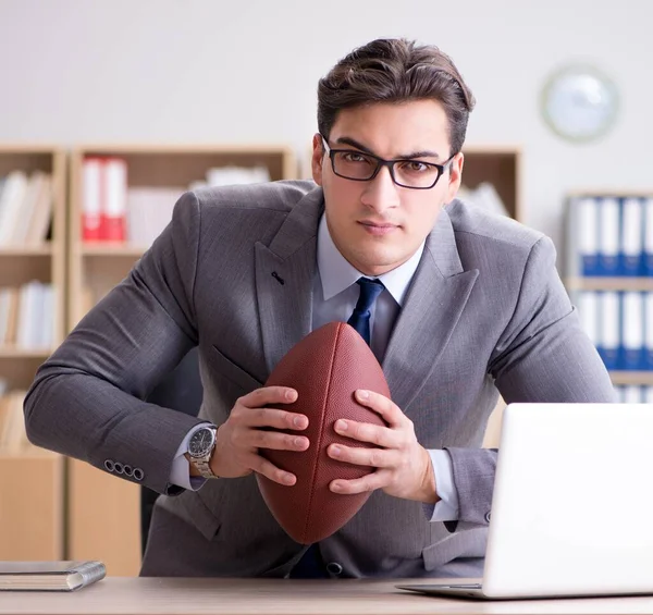 Empresario con fútbol americano en la oficina —  Fotos de Stock