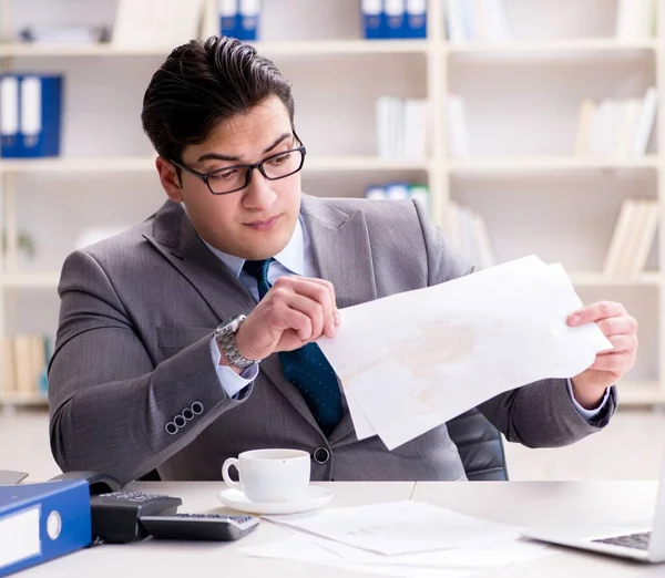 Businessman spilling coffee on important documents — Stock Photo, Image