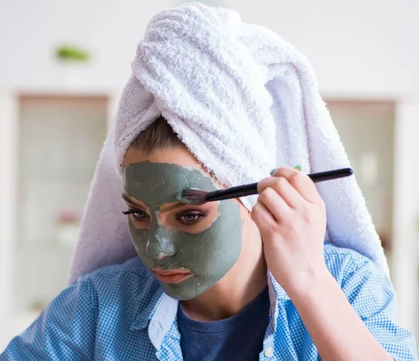 Kvinna tillämpa lera mask med borste hemma — Stockfoto