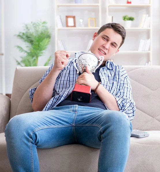 Young man student watching football at home — Stock Photo, Image