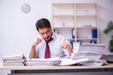 Genç işadamı ofisteki aşırı işten memnun değil.