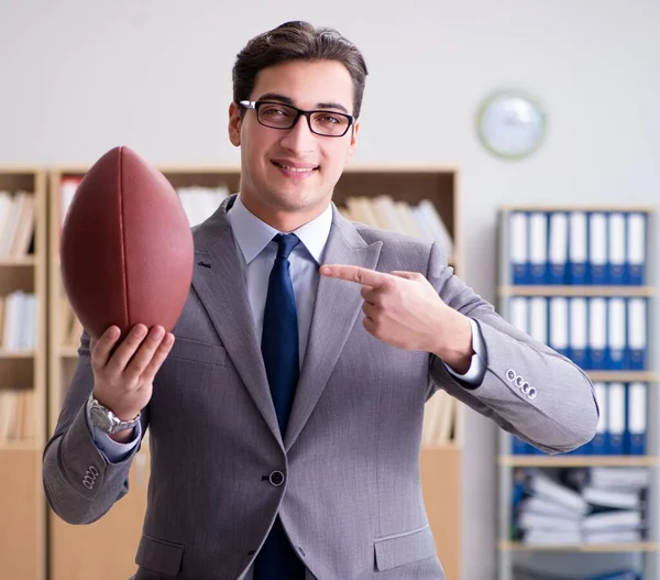 Empresario con fútbol americano en la oficina — Foto de Stock