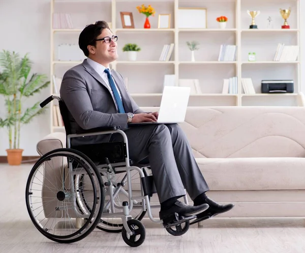 Dsabled businessman on wheelchair working home