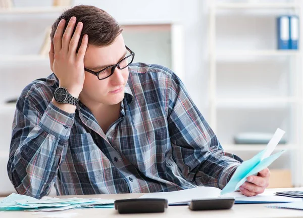 Young man frustrated at his house and tax bills — Stock Photo, Image