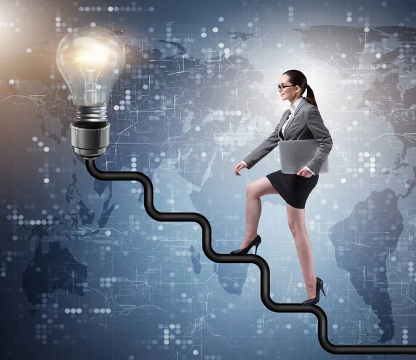 Businesswoman climbing career ladder towards light bulb — Stock Photo, Image