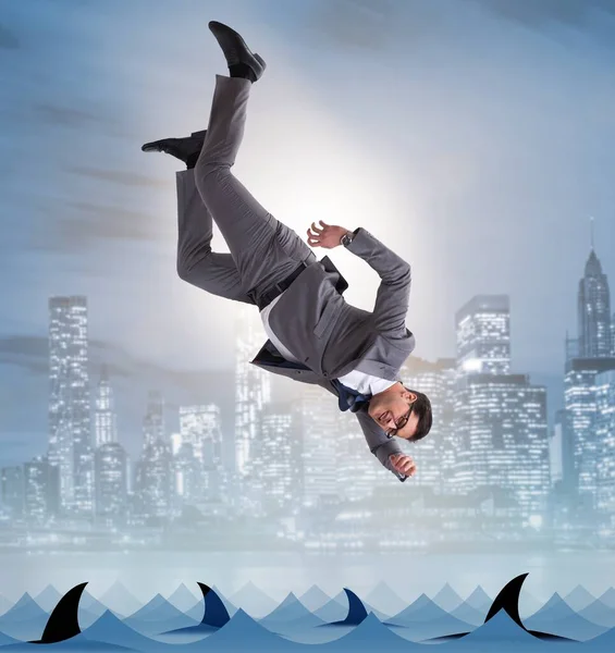 Businessman falling into sea with sharks — Stock Photo, Image