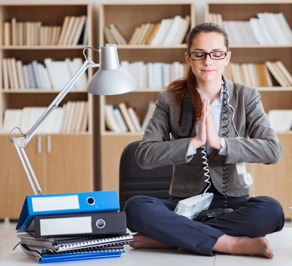 Businesswoman meditating in the office — Stock Photo, Image