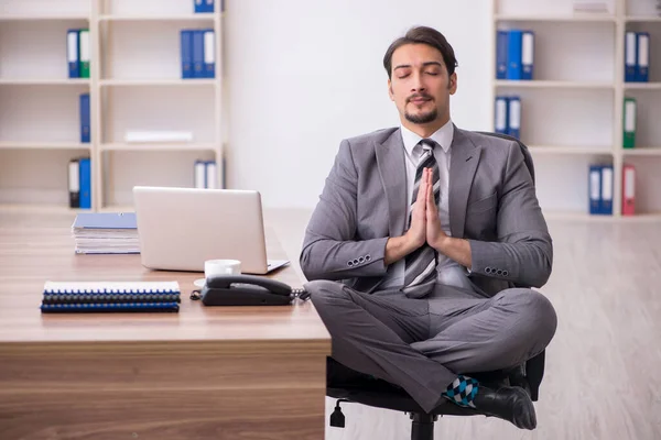 Young attractive male employee sitting at workplace — Stock Photo, Image