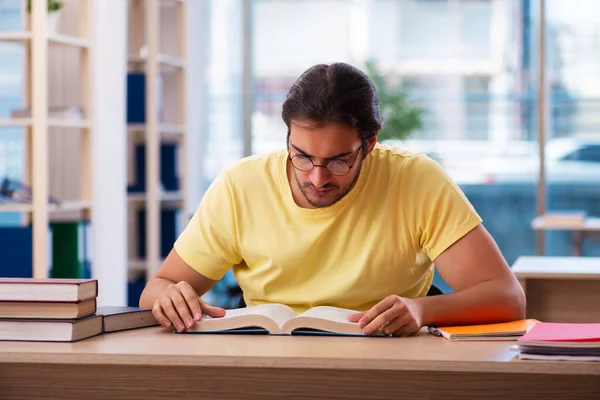 Young male student preparing for exams in the classroom — Stock Photo, Image