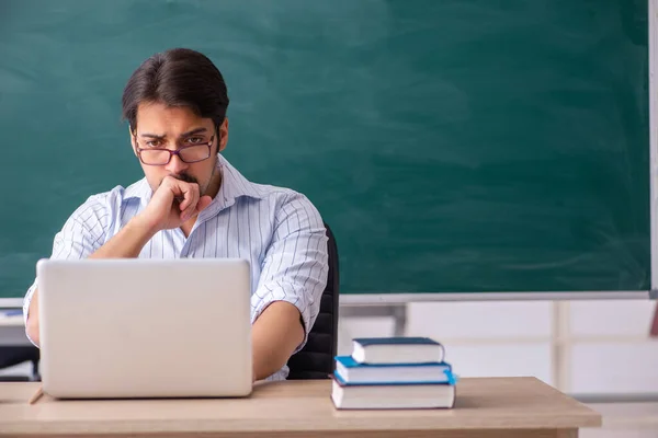 Young male teacher in telestudying concept — Stock Photo, Image