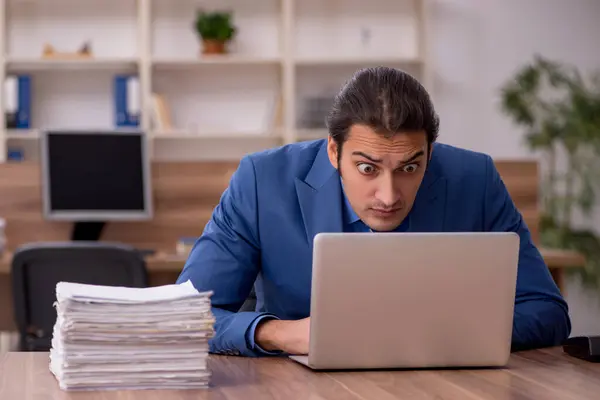 stock image Young male employee and a lot of work in the office