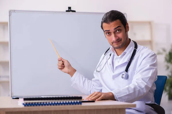 Young male doctor working in the clinic — Stock Photo, Image