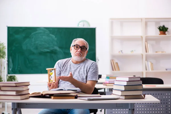 Old male student in time management concept