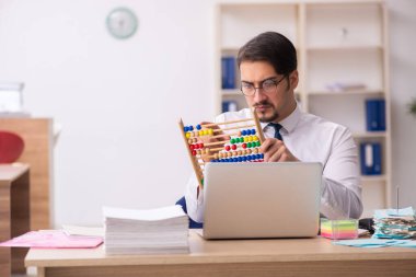 Bütçe planlama konseptinde abaküs tutan genç bir muhasebeci.