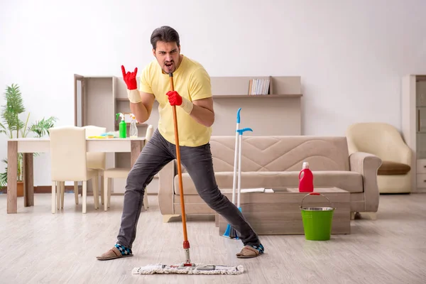 Jonge mannelijke aannemer schoonmaken van het huis — Stockfoto