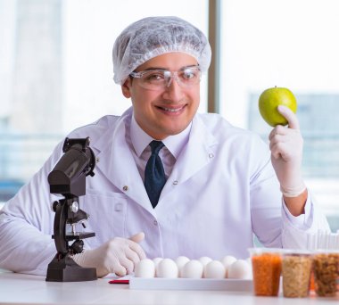 Besin uzmanı gıda ürünlerini laboratuarda test ediyor.