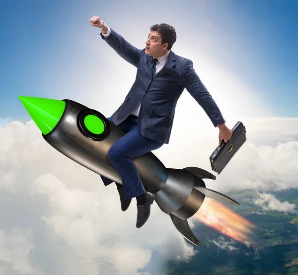 Male businessman flying on rocket in business concept