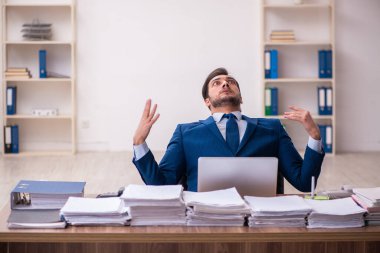 Genç işadamı ofisteki aşırı işten memnun değil.